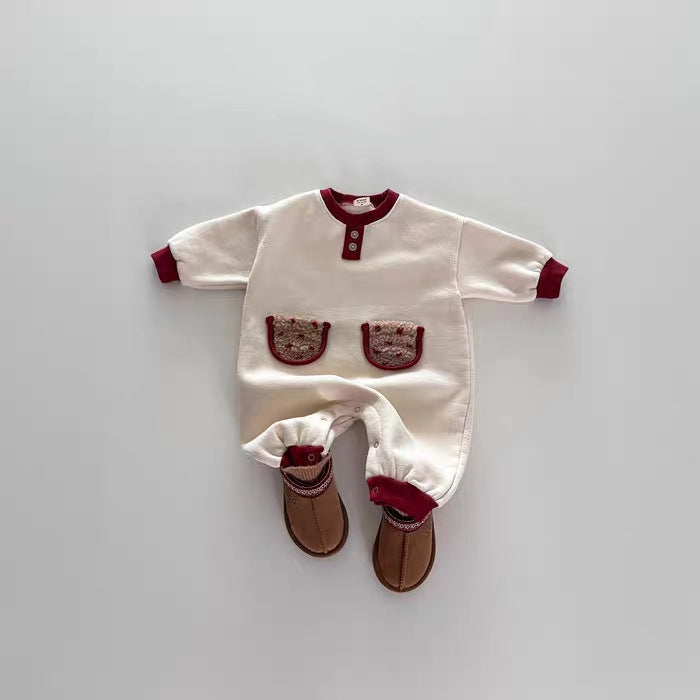 Navy blue baby romper with white accents on a white background