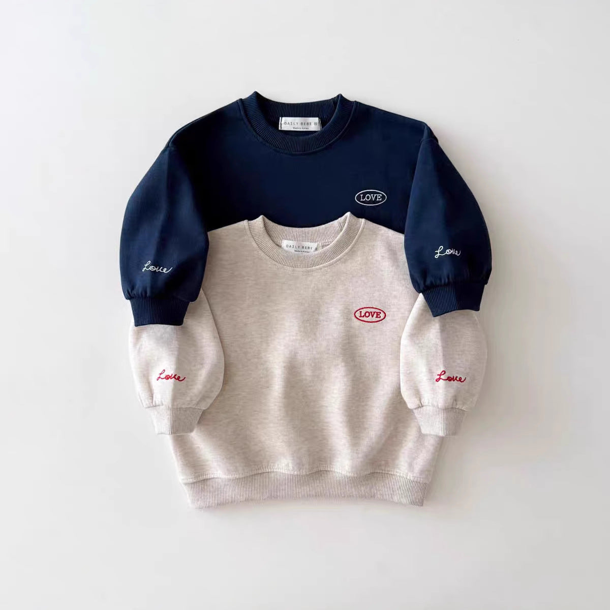 Two-tone navy and beige sweatshirt with Levi's branding on a white background