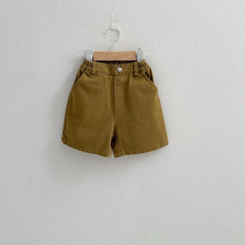 Brown shorts hanging on a white wall