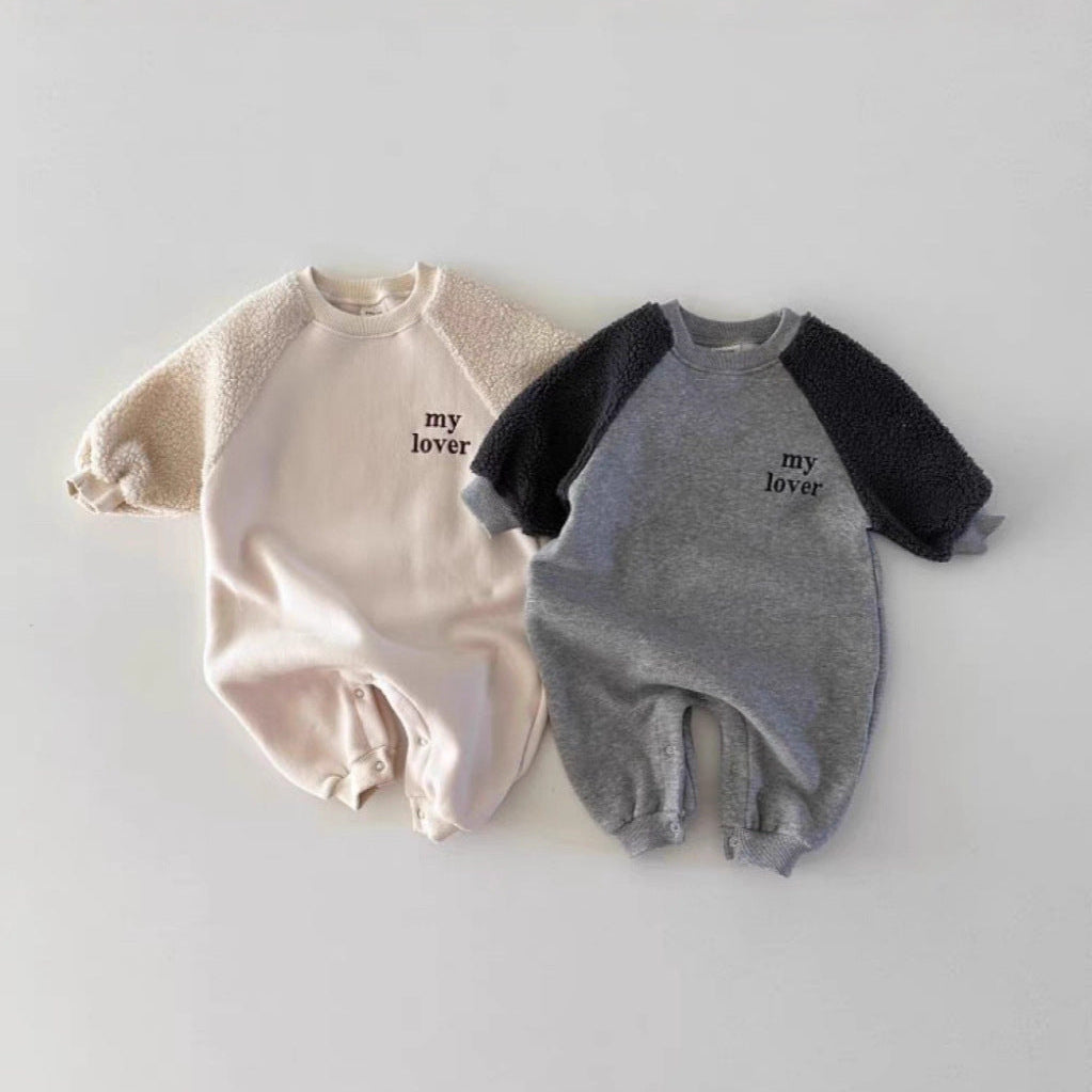 Two baby rompers, one beige and one gray with black sleeves, on a light gray background.
