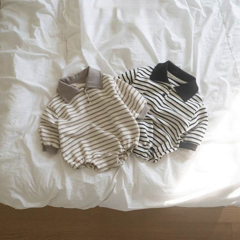 Two pairs of striped baby rompers on a white bedspread.